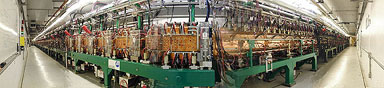 The Spallation Neutron Source's 1000-foot linear accelerator, shown from either end in this trick photo, is actually nearly perfectly straight, with an allowance of 7 millimeters to compensate for the Earth's curvature. A proton is accelerated down the linac from a stop to nearly the speed of light in 2 microseconds.
