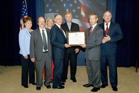 Oak Ridge National Laboratory has earned a White House Closing the Circle Award for outstanding federal environmental stewardship practices. Pictured here (l to r) are: Kathye Settles (Fleet Manager), Joe Herdon (Director of ESHQ), Susan Michaud (Pollution Prevention Program Manager), Herb Debban (Director of Facility Operations), Lynn Cox (Garage Supervisor), Joseph Cascio (Federal Environmental Executive) and John Mizroch (DOE's Principal Deputy Assistant Secretary Office of Energy Efficiency and Renewable Energy).
