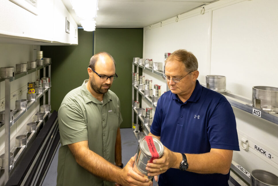 two researchers study a tool in a lab