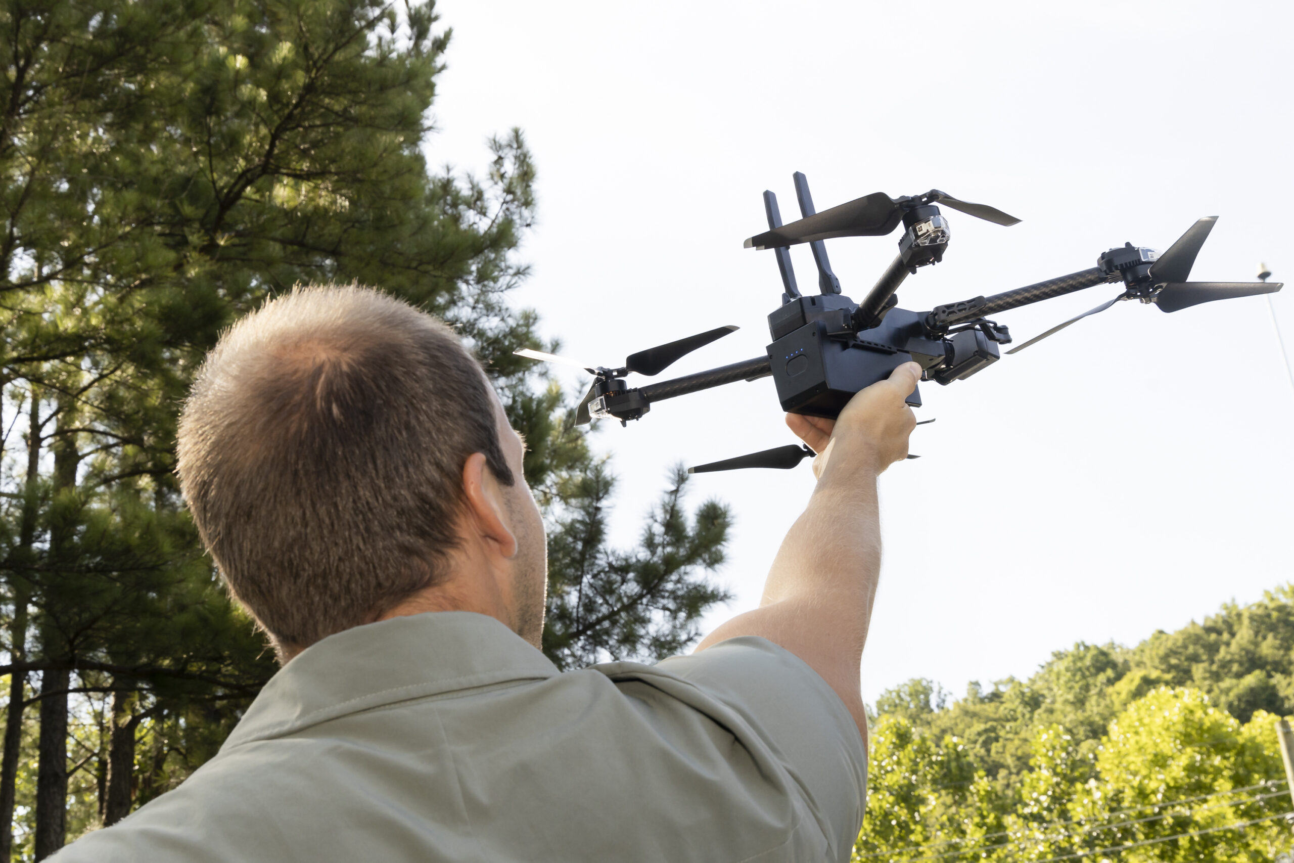 A person launching a drone