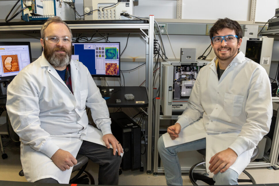 Two scientists sitting in front of equipment
