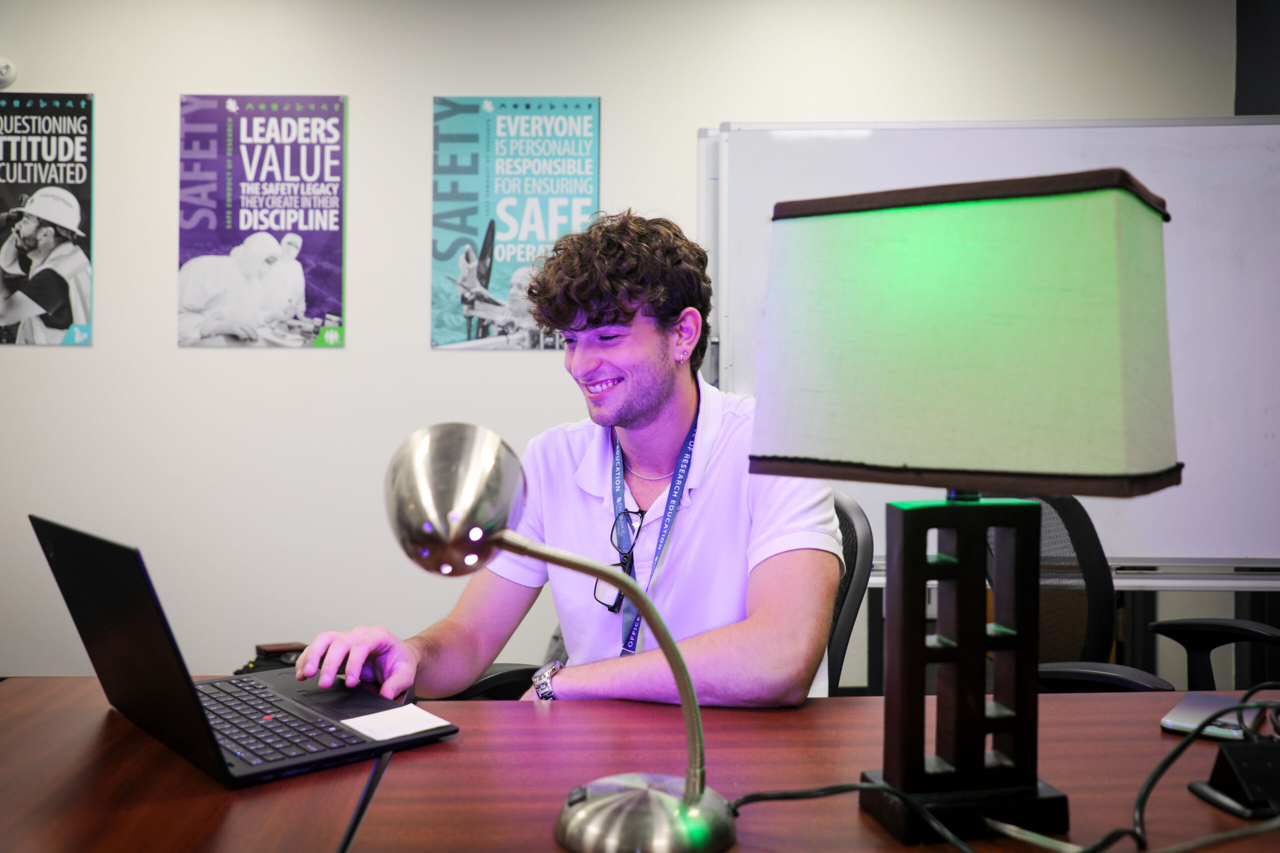 man sitting at a desk with a laptop in front of him