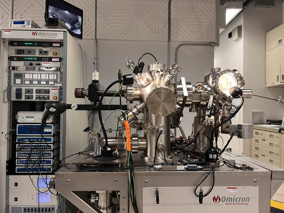 A large metallic piece of equipment next to a metal cabinet