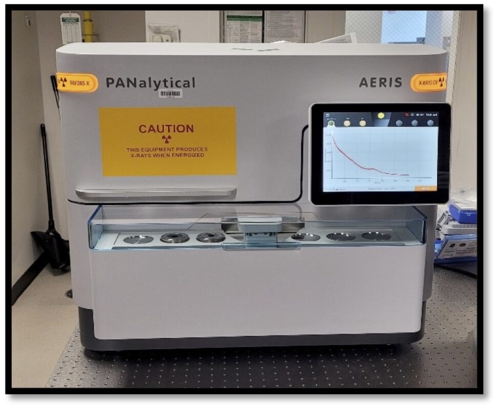 A large enclosed science equipment machine with an external monitor