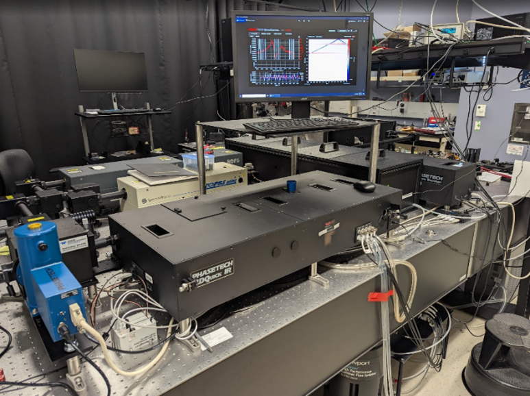 a metal tabletop with several equipment boxes and a monitor