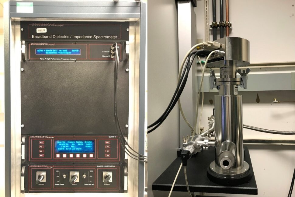 A panel with keys and displays shows wires connected to a metal cylindar