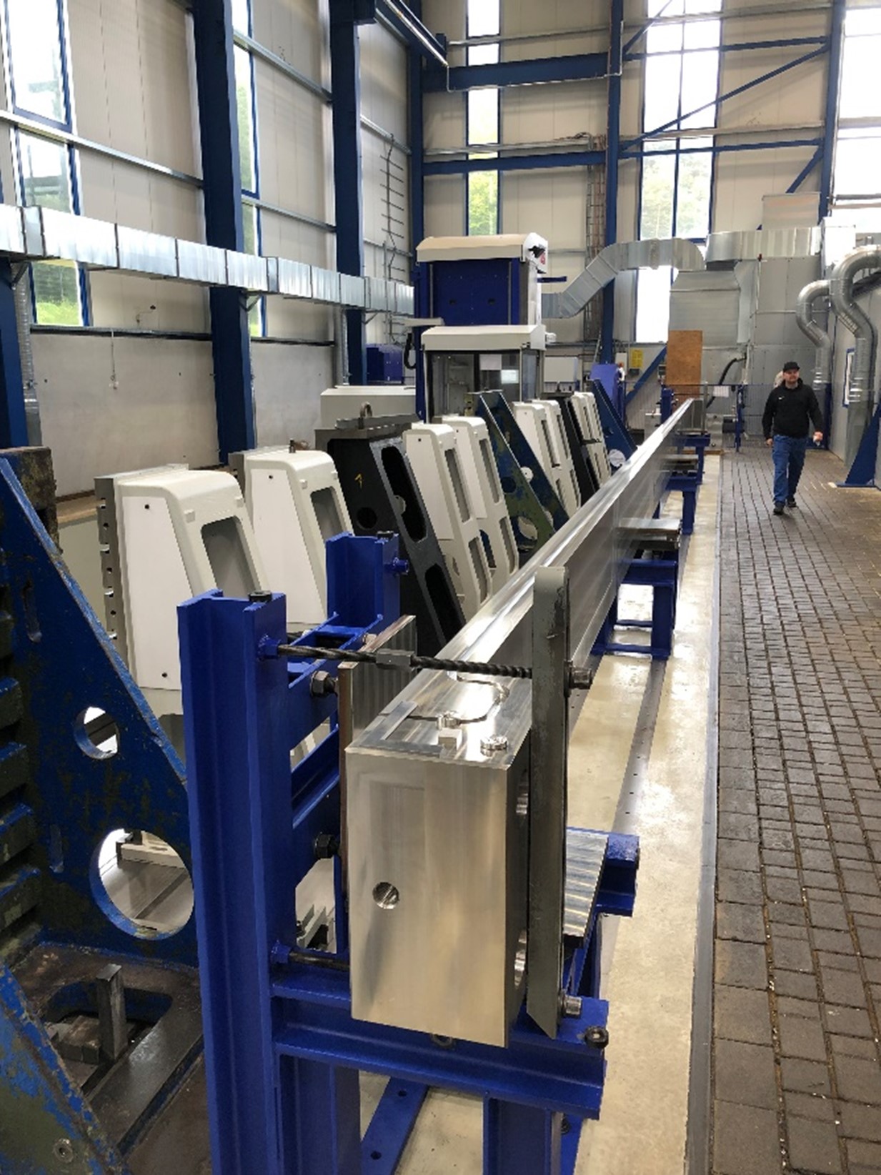 50 foot long tie plate which looks like a big metal blade with blue hardware holding it