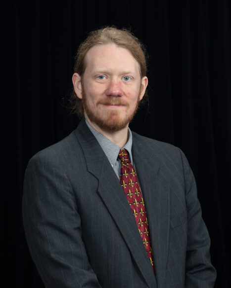 Studio portrait of Frank Gonzalez, radiation detection and imaging scientist at Oak Ridge National Laboratory, against a neutral background, facing the camera.