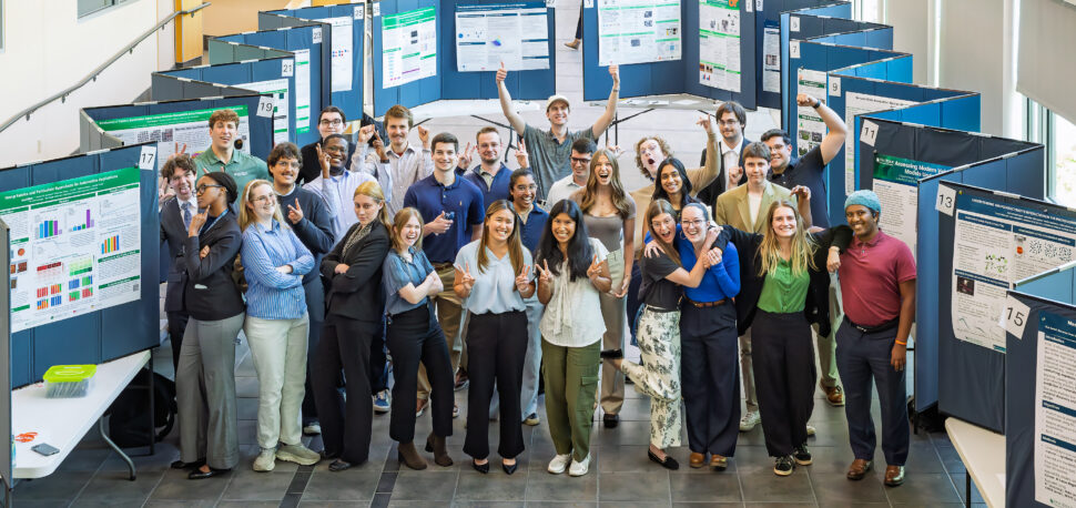 Students present scientific research posters during the Spring 2026 Student Poster Session at Oak Ridge National Laboratory. Attendees gather inside 5700 Main Street to discuss research projects and workforce development opportunities.