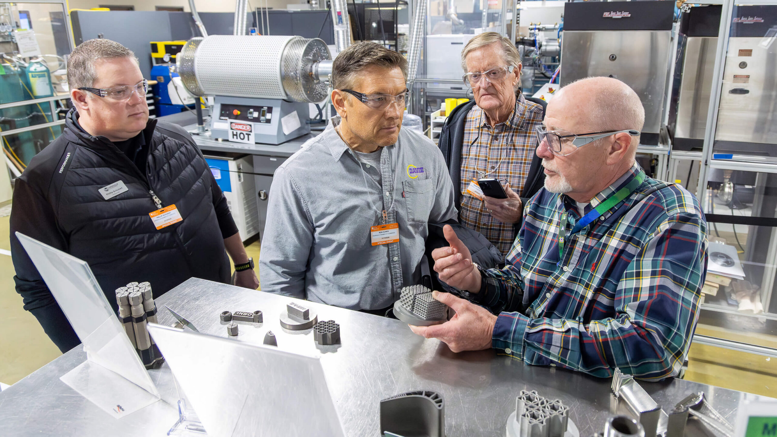 ORNL Industrial and Economic Development Manager Jesse Smith, right, leads a tour of the finer points of 3D printing techniques with potential industry partners following a Knoxville Chamber event.