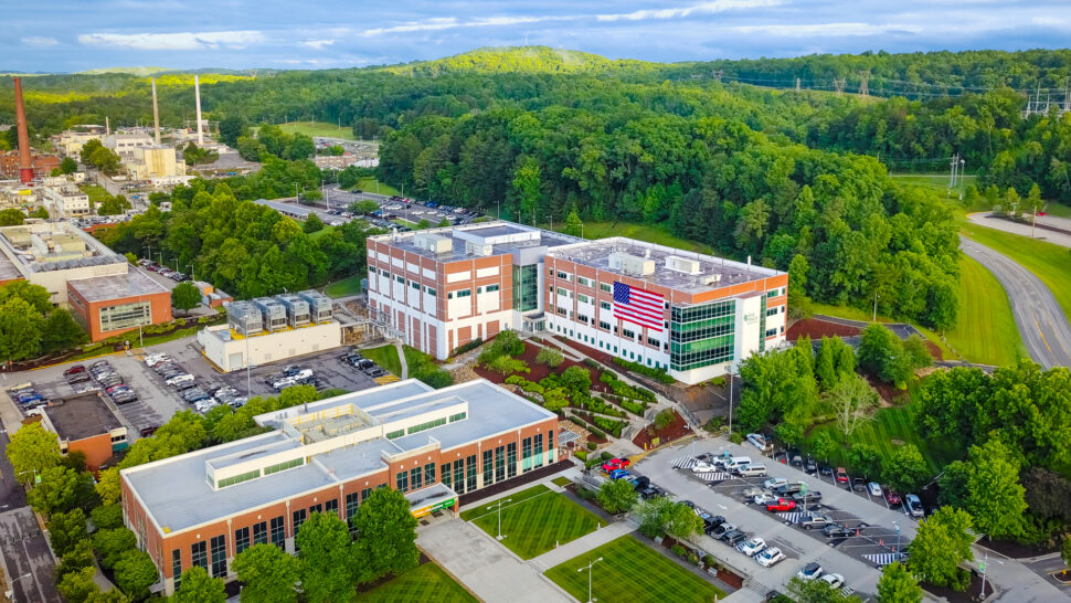 An overhead picture of Oak Ridge National Laboratory's main campus, with the American flag displayed outside one of the buildings.
