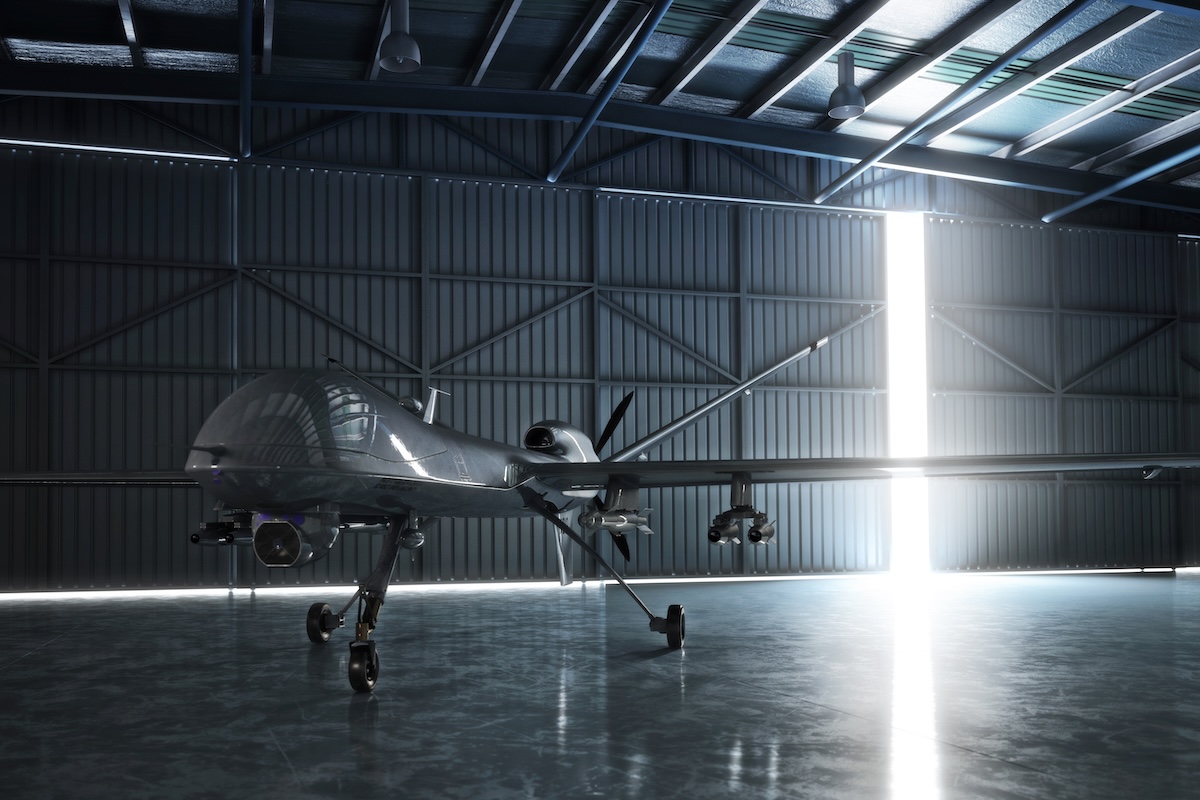 Lone drone U.A.V aircraft awaiting a military mission in a hanger. Image from Envato