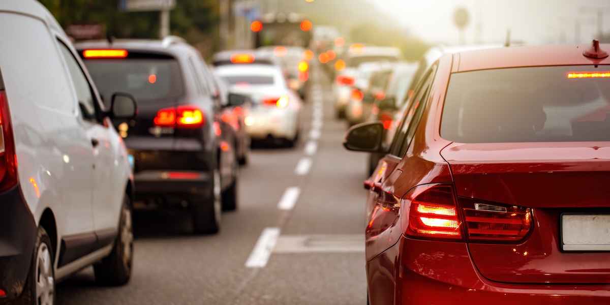 Rear view of modern car with brake lights on during rush hour. Image from Envato