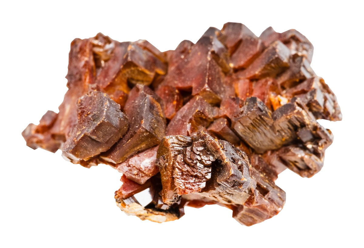 Close up of sample of rough crystalline vanadinite mineral isolated on white background. Image from Envato