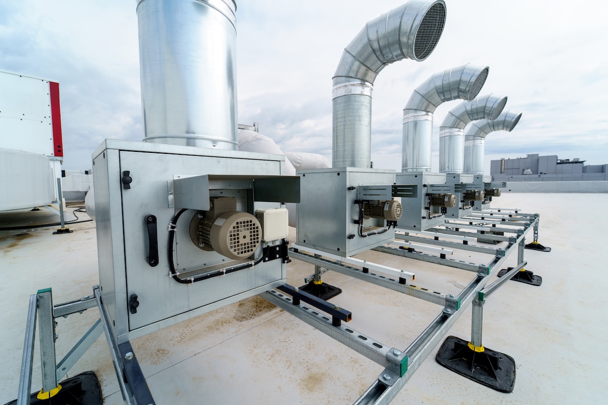 The air conditioning and ventilation system of a large industrial building is located on the roof. It consists of air ducts, air conditioning, smoke removal and ventilation. Image from Envato