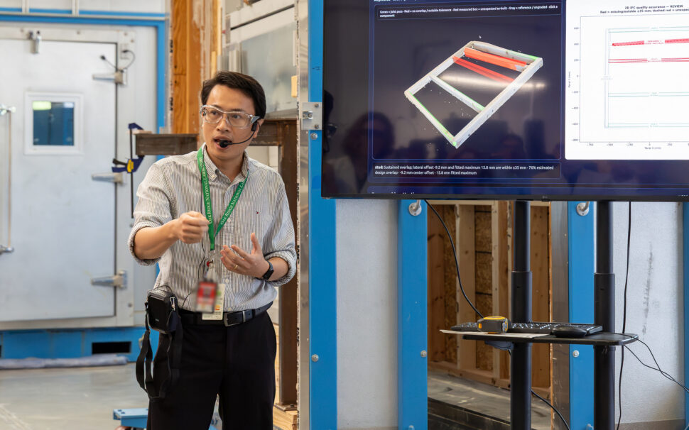 Dai Tran demonstrates an automated quality control system for prefabricated construction to BTRIC Strategic Advisory Board members during a laboratory tour.