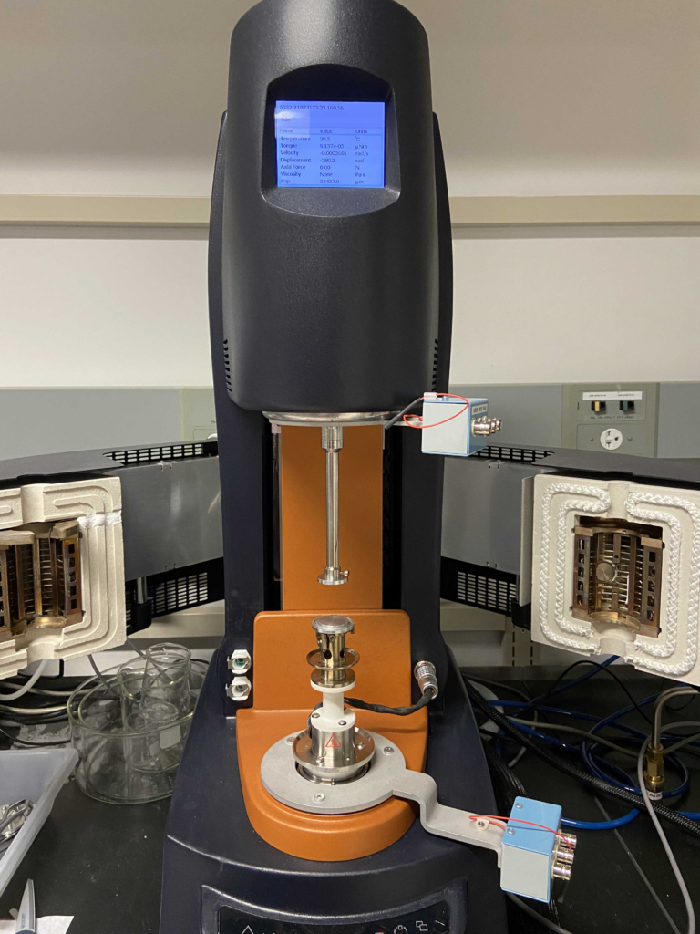 A tall, skinny black piece of equipment with a metal probe