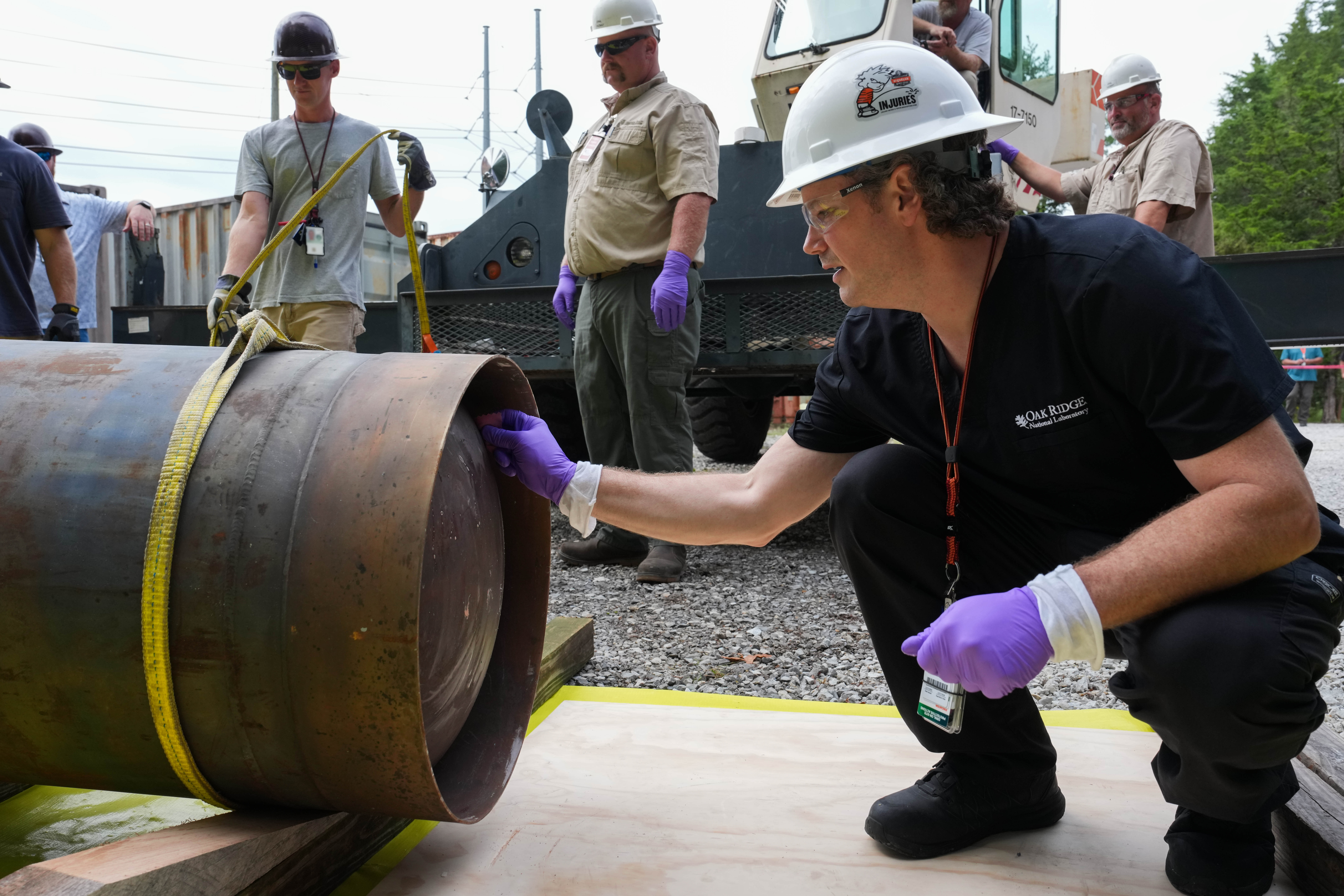 ORNL staff prepare containers for shipment to a research reactor at Abilene Christian University in Texas.