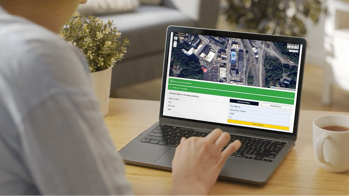 Person uses a building energy assessment tool on a laptop.
