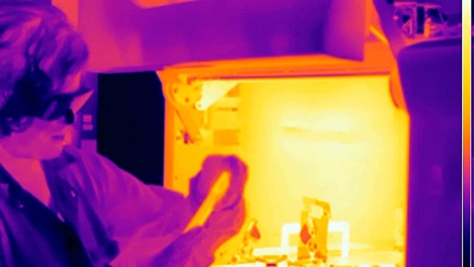 Thermal image of a person working with heated equipment.