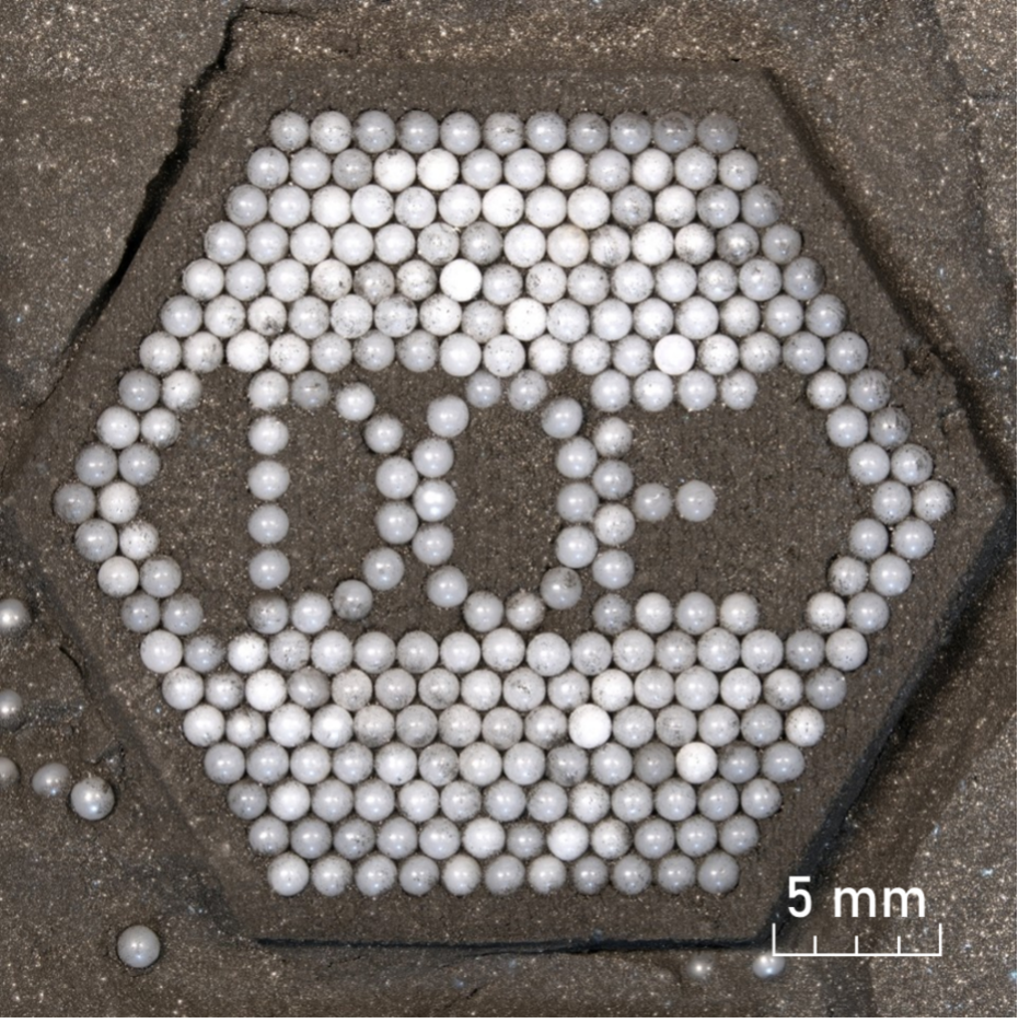 TRISO fuel particles arranged to form the letters ORNL.