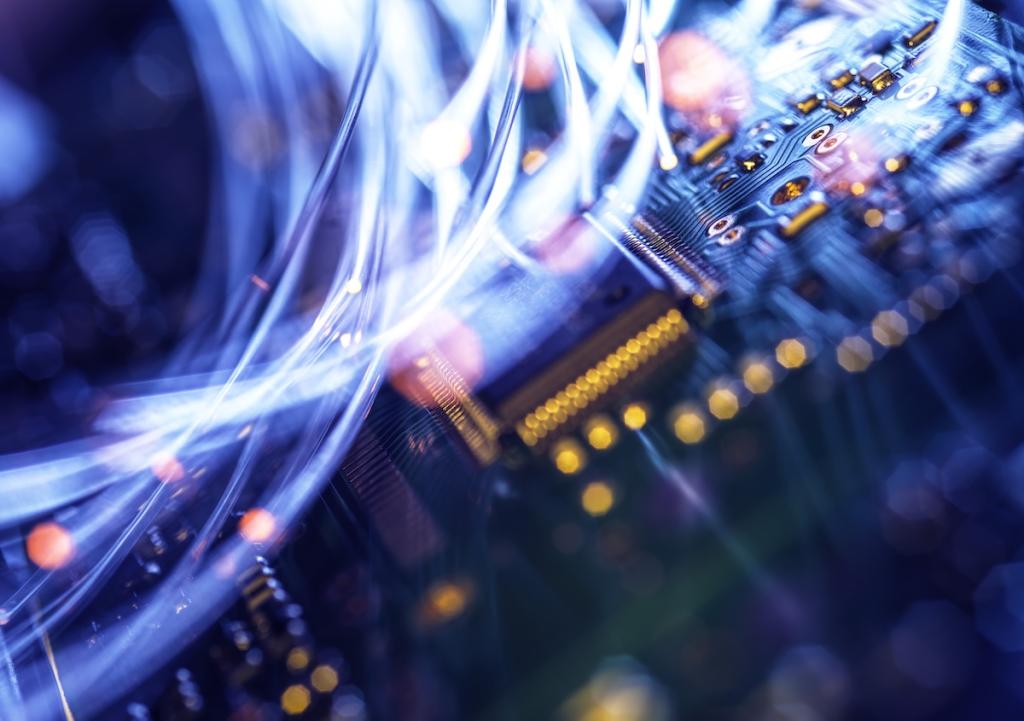 Fiber-optic cables carrying data across electronic circuitry.